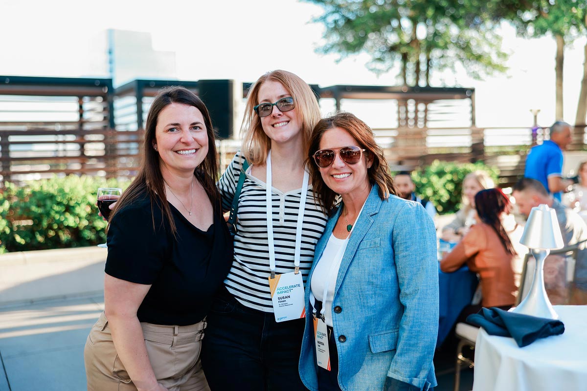 Geron employees smiling outdoors at a welcome party
