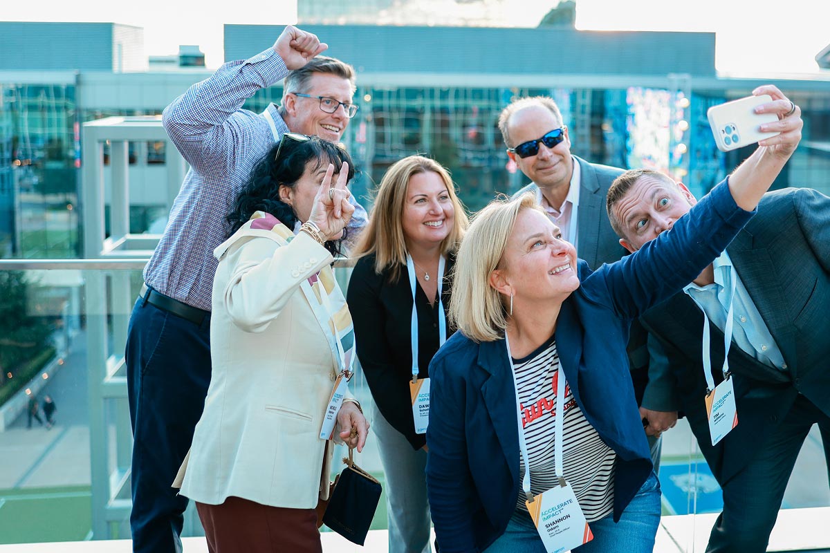 Geron leadership taking a selfie on an outdoor rooftop