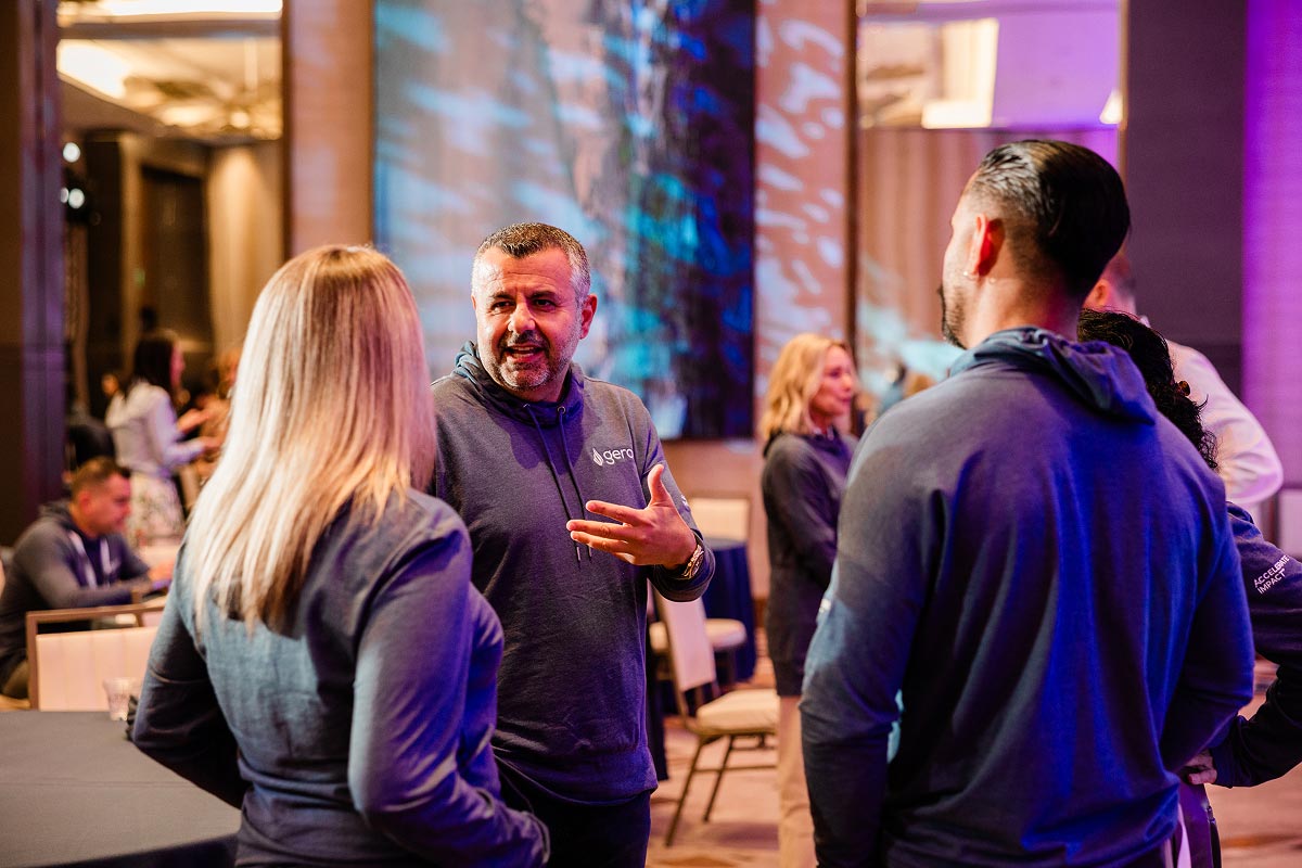 Geron CEO talking with employees in a ballroom