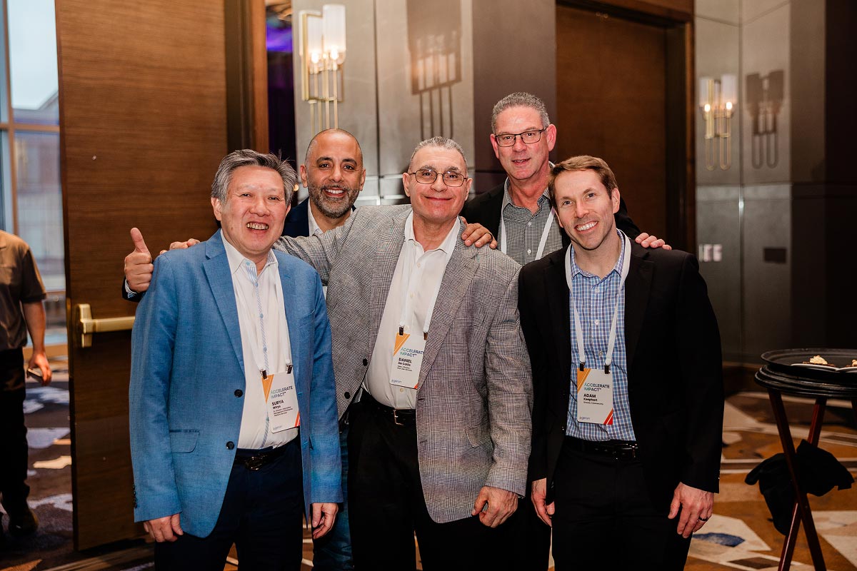 Geron employees smiling at an awards event in a ballroom