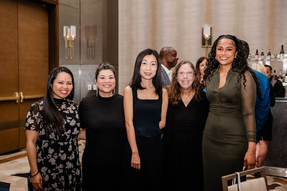 Geron employees smiling at an awards dinner