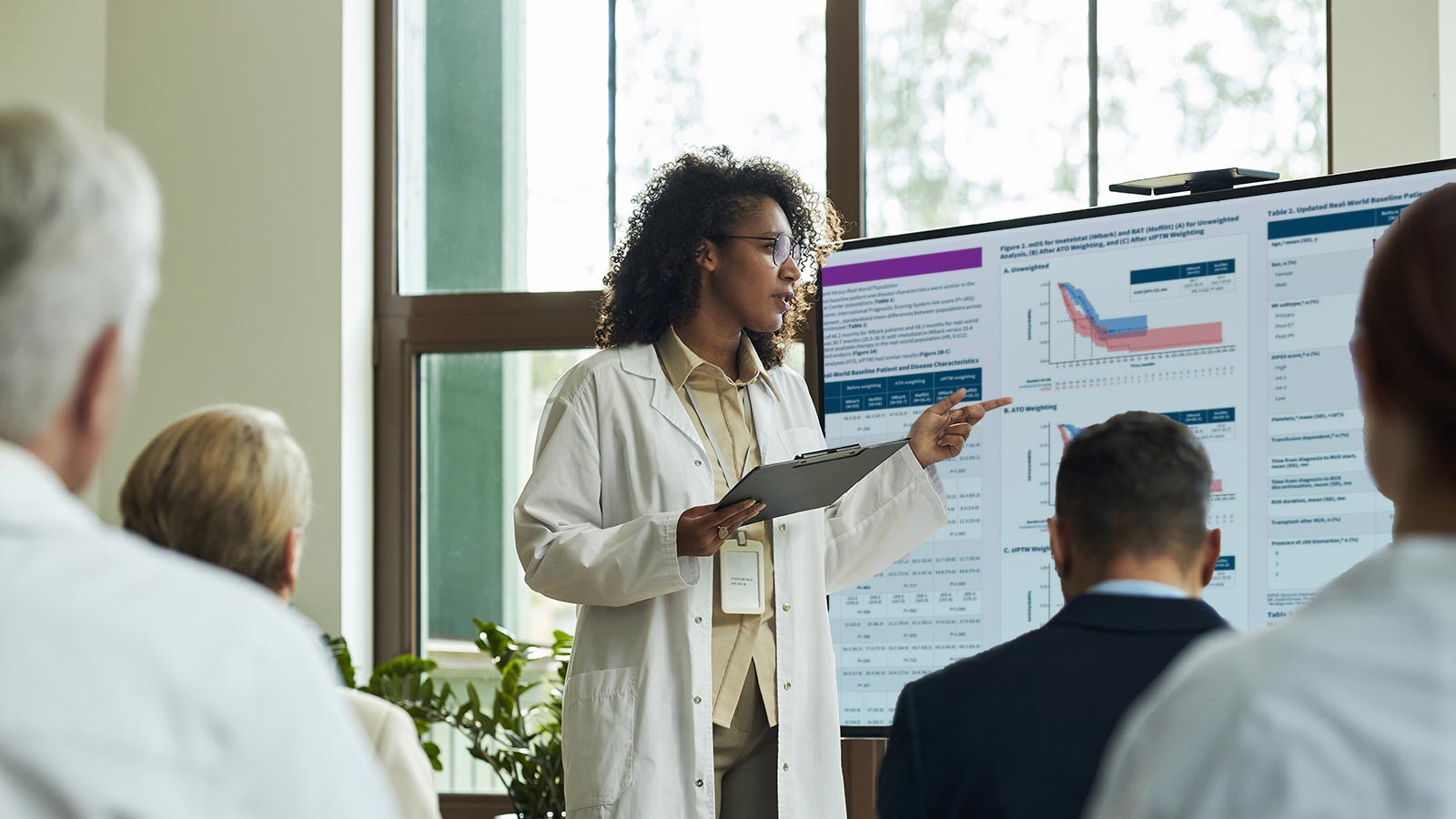doctor showing Geron charts to peers