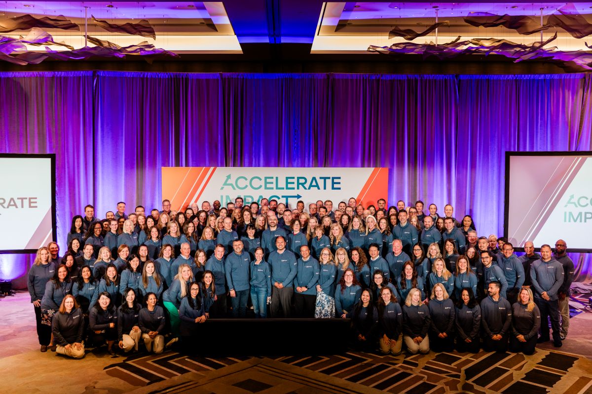 Geron full team on stage in ballroom