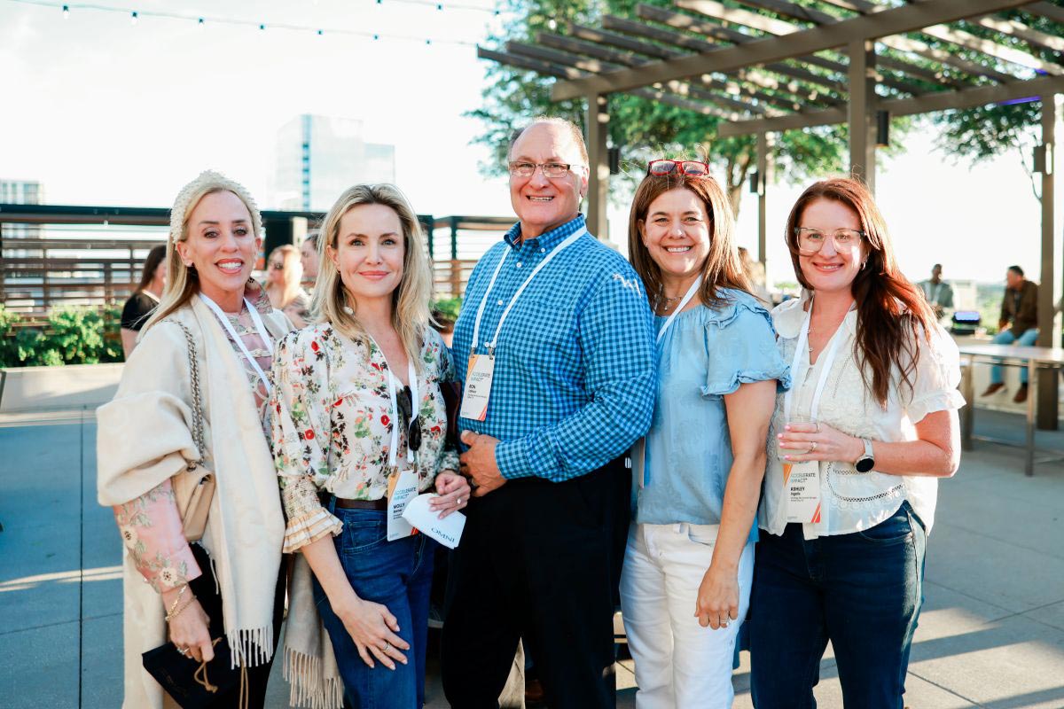 geron employees smiling on outdoor rooftop