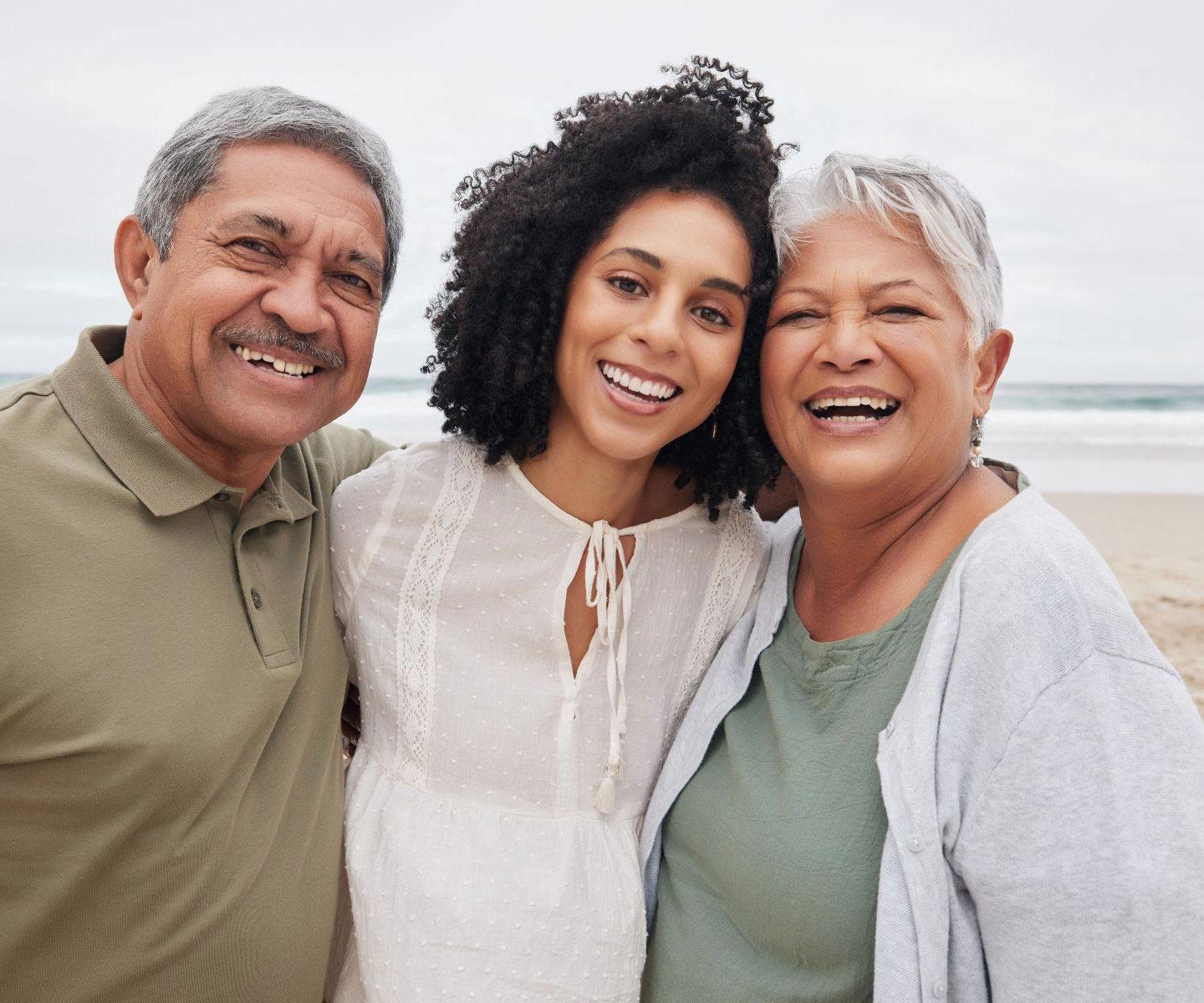 portrait, happy woman and senior parents at beach on holiday, vacation or travel outdoor.
