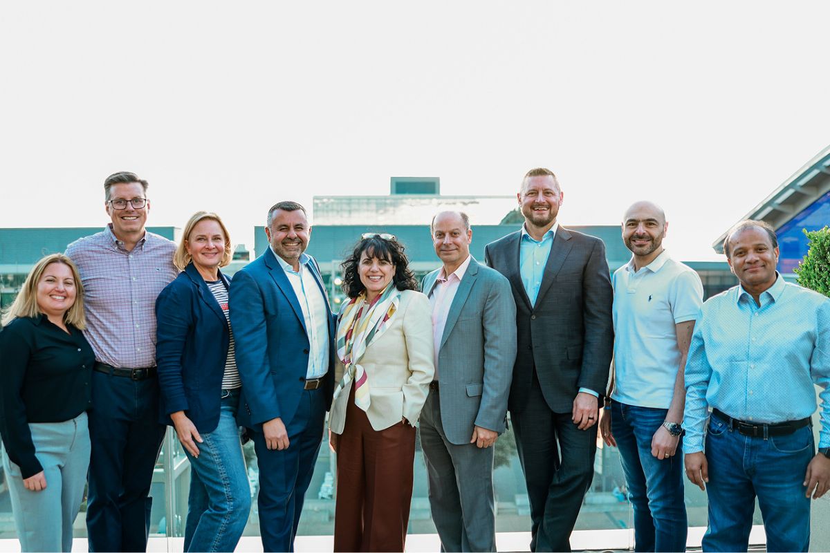 geron leadership standing on outdoor rooftop