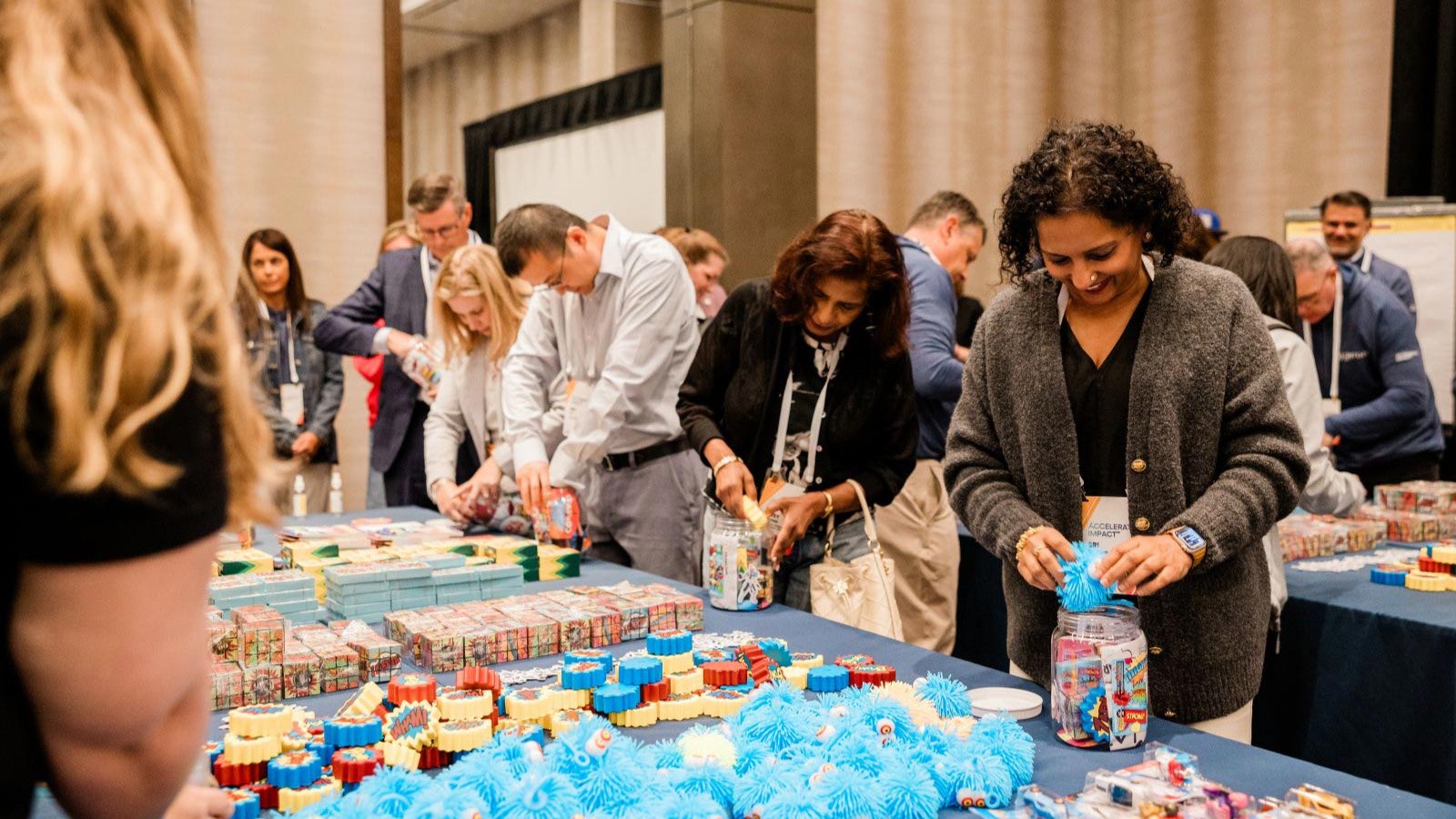 geron employees filing bins with toys in ballroom