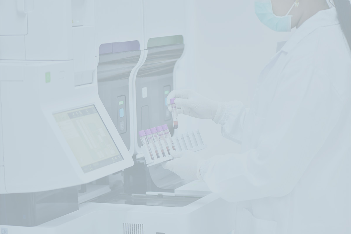 Medical laboratory technician operating an automated diagnostic analyzer